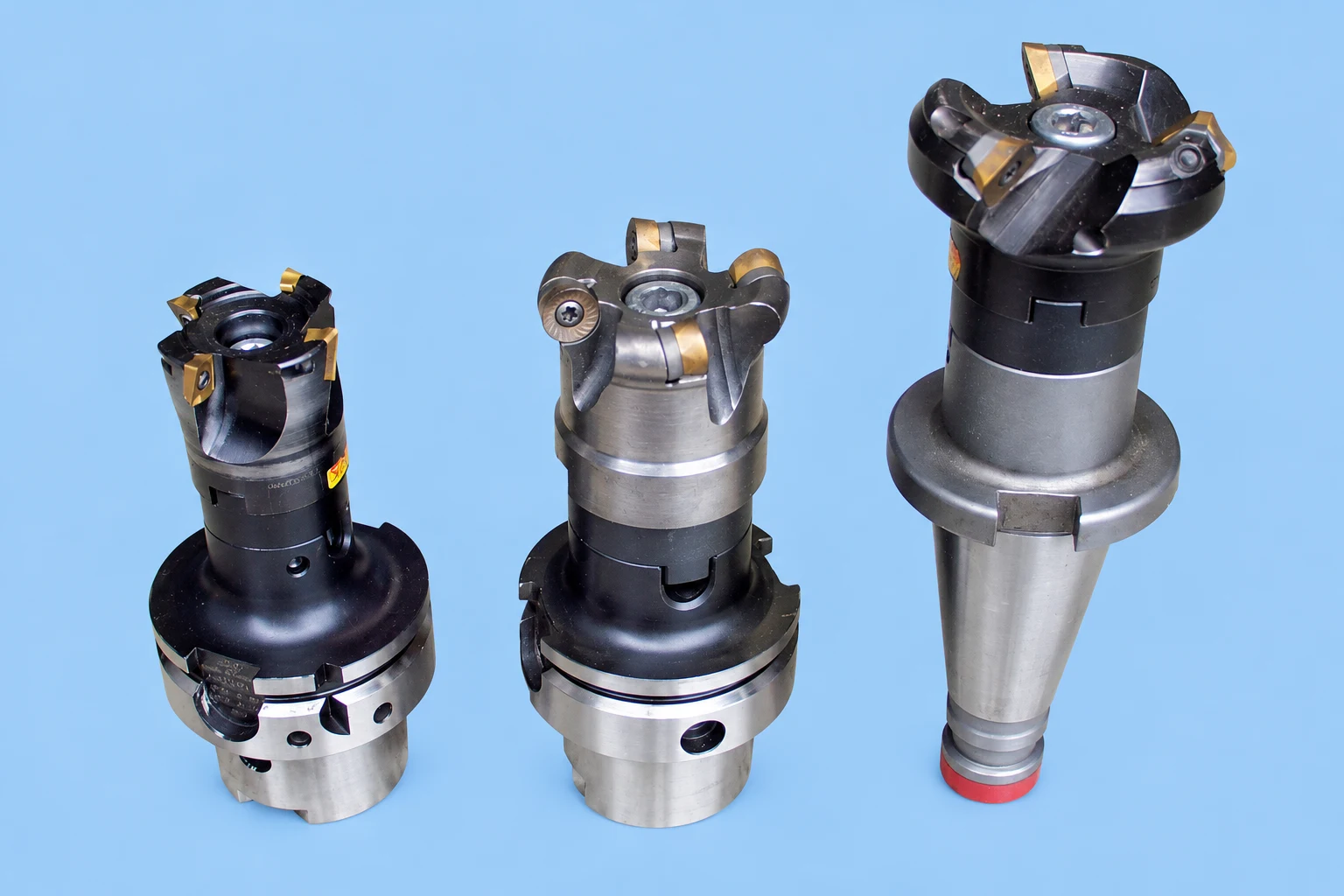 Three milling cutter assemblies on blue backing; photo-based editorial edit
