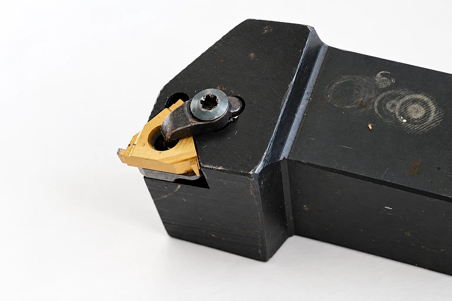 Photo-based editorial adaptation of a turning holder and clamped insert; generic tooling reference, not a verified VNMG331 assembly.