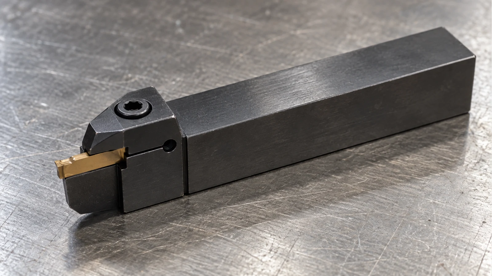 Narrow carbide grooving insert securely clamped in a holder