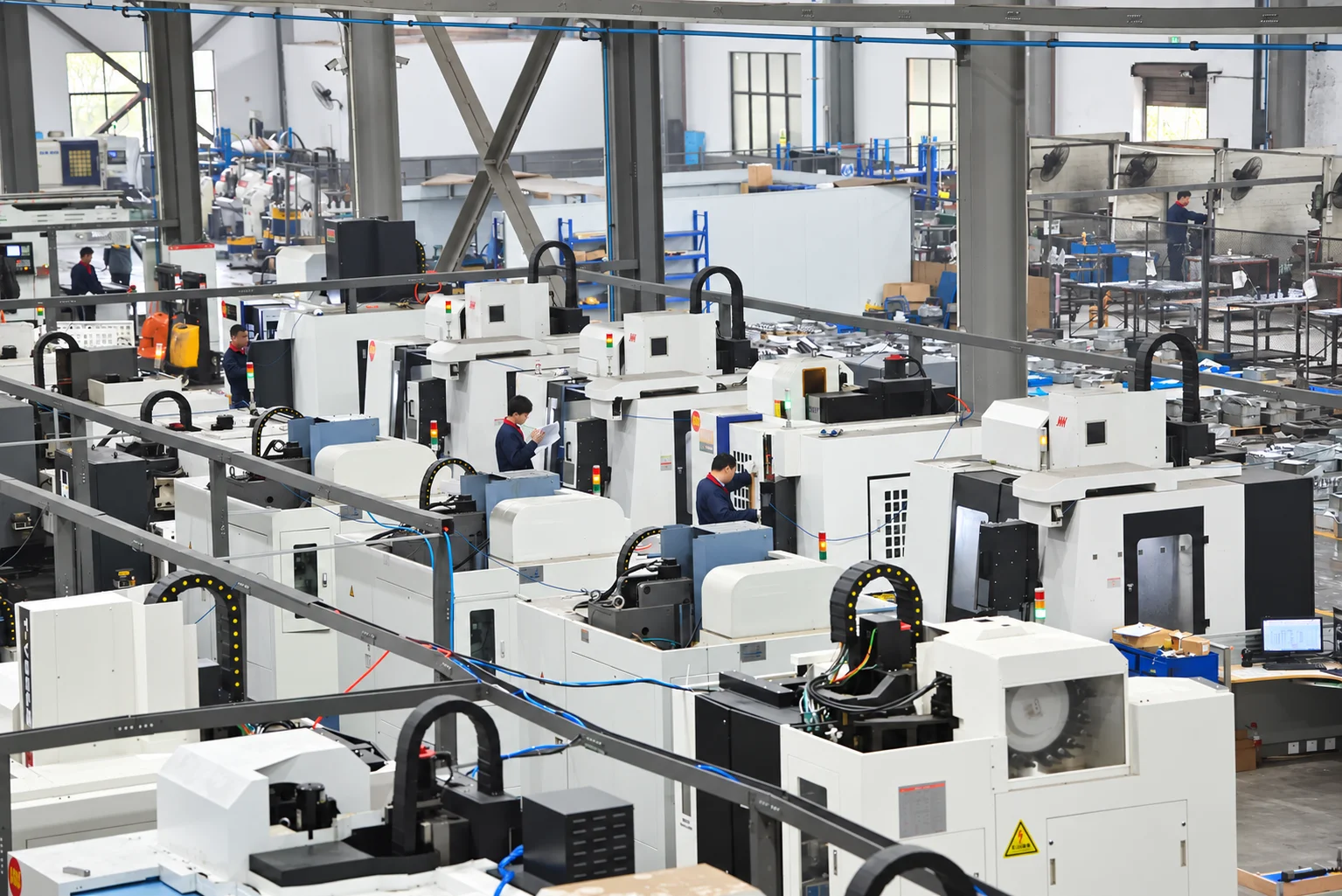 Rows of CNC equipment on the factory floor